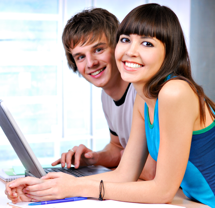 students smiling on a laptop